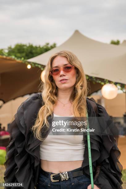 Fiona Jane wears Frame denim jeans and belt, Reformation vest top, Coppenhagen Muse jacket, Maje bag and Komono sunglasses at Victoria Park on August...