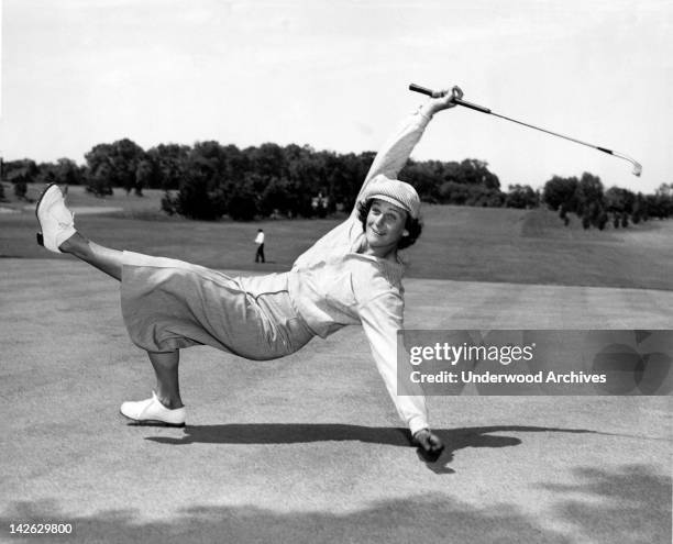 Babe Didrikson Zaharias uses a bit of body english to sink a putt at the All-American tournament at Chicago's Tam-O'Shanter Country Club, Chicago,...