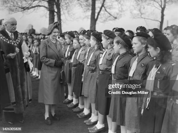 Princess Elizabeth inspecting a group of Girl Guides during a visit to Swindon, Wiltshire, 15th November 1950. She is accompanied by the mayor,...