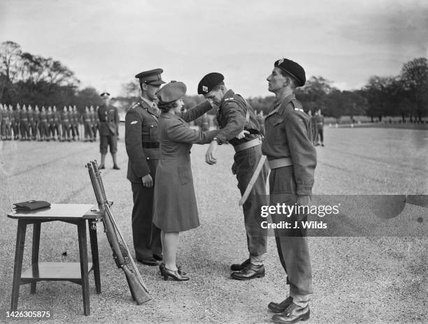 Princess Elizabeth , presents the Sam Browne belt to Officer Cadet JD Carter of Maidenhead, during the passing out parade of the No 100 Officer...