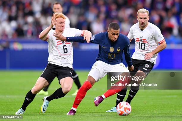 Kylian Mbappe of France holds off Nicolas Seiwald of Austria during the UEFA Nations League League A Group 1 match between France and Austria at...