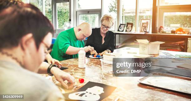 autism, down syndrome and disability classroom art activity, learning skills development and physical therapy. nurse, special needs creative teacher and healthcare therapist help disabled community - autistic adult imagens e fotografias de stock
