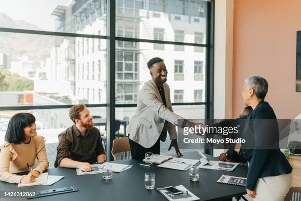 b2b partnership, collaboration or client handshake in business meeting for welcome, onboarding or thank you. agency team shaking hands and happy with agreement, deal or negotiation strategy interview - customer relationship management stockfoto's en -beelden