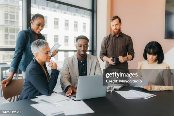 business people planning marketing strategy on laptop, reading documents for project in meeting and discussion in workshop in office. black man working at diverse global  company with corporate team - responsive web design stockfoto's en -beelden