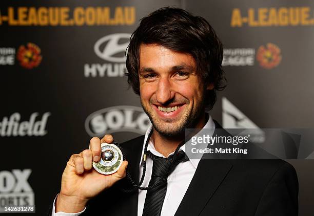 Thomas Broich of Brisbane Roar poses with the 2012 A-League Johnny Warren Medal at Doltone House Darling Island Wharf on April 10, 2012 in Sydney,...