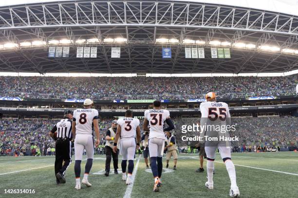 Denver Broncos Captains Russell Wilson, Brandon McManus, Justin Simmons and Bradley Chubb of the Denver Broncos walk out for the coin toss during a...
