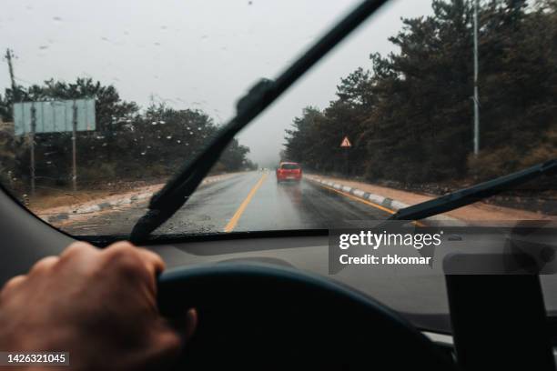 driving in hard weather conditions, rain on the windshield - windshield wiper stock pictures, royalty-free photos & images