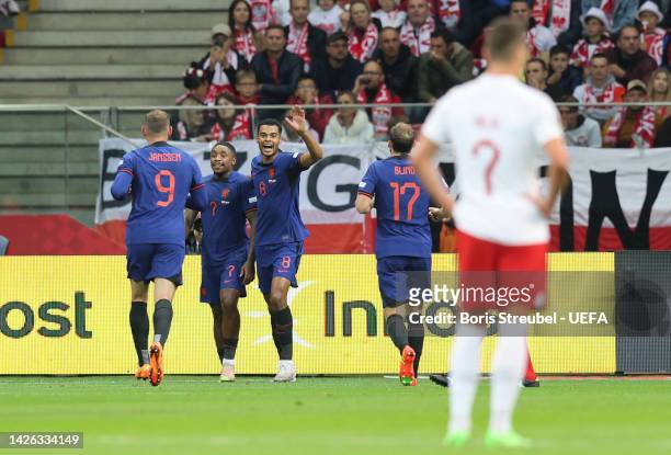 Steven Bergwijn of Netherlands celebrates with teammates Vincent Janssen and Cody Gakpo after scoring their team's second goal during the UEFA...