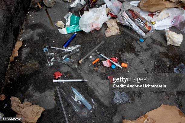 Used needles are seen on the street during a city sweep of a homeless encampment, September 22, 2022 in New York City, New York.