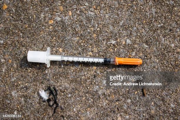Used needle is seen on the street during a city sweep of a homeless encampment, September 22, 2022 in New York City, New York.