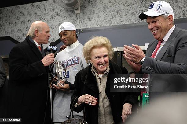 New York Giants co-owners Ann Mara and Steve Tisch celebrate as Victor Cruz of the New York Giants is interviewed by Terry Bradshaw in the locker...
