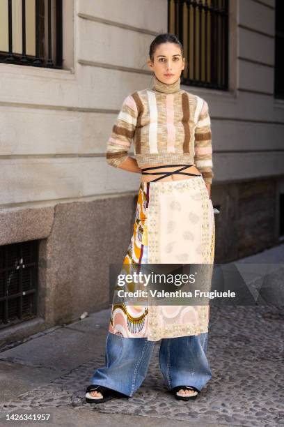 Diletta Bonaiuti is seen wearing a cropped turtleneck jumper and a skirt over denim pants outside Dsquared show during the Milan Fashion Week -...