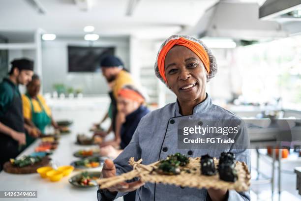 senior woman showing a meal she'd prepared at cooking class - course meal stock pictures, royalty-free photos & images
