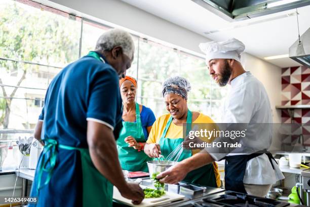chef teaching students during cooking class - cooking school stock pictures, royalty-free photos & images