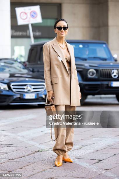 Tamara Kalinic is seen wearing a camel coat, bra and pants and orange shoes outside Max Mara show during the Milan Fashion Week - Womenswear...