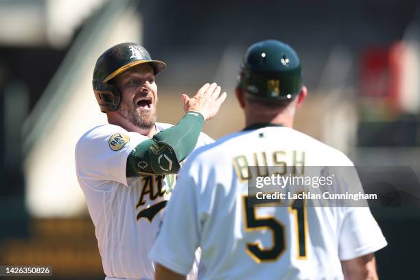 Stephen Vogt of the Oakland Athletics reacts after hitting a three-run triple in the bottom of the third inning against the Seattle Mariners at...