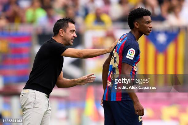 Head Coach Xavi Hernandez of FC Barcelona gives instructions to Alejandro Balde of FC Barcelona during the LaLiga Santander match between FC...