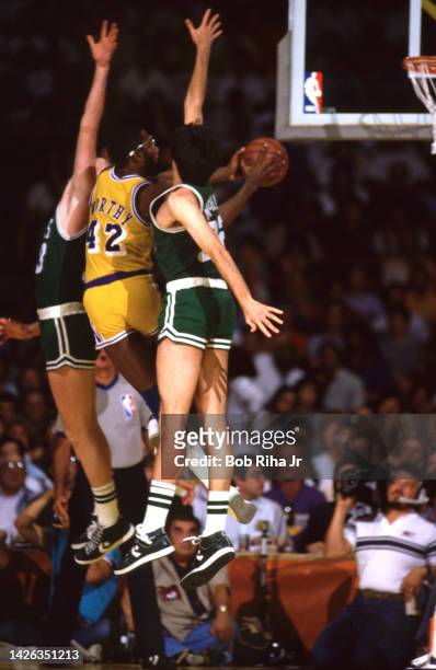 Lakers James Worthy is double-teamed by Celtics Larry Bird and Kevin McHale during 1985 NBA Finals between Los Angeles Lakers and Boston Celtics,...