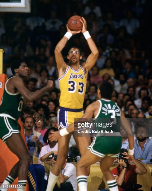 Lakers Kareem Abdul-Jabbar gets ready to pass the ball as Robert Parish and Dennis Johnson defend during 1985 NBA Finals between Los Angeles Lakers...