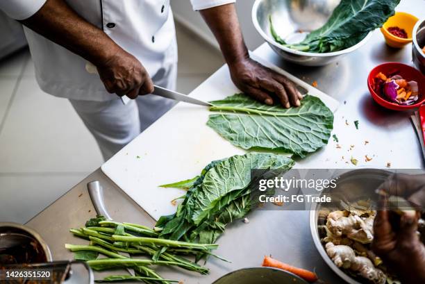 human hands preparing a vegetarian dish - cut cabbage stock pictures, royalty-free photos & images