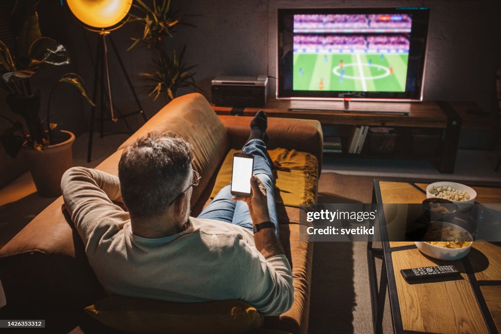 Watching soccer game at home