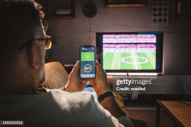 watching soccer game at home - man watching tv alone imagens e fotografias de stock