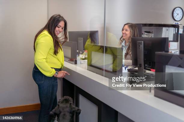 pet friendly business - bank office clerks stock pictures, royalty-free photos & images