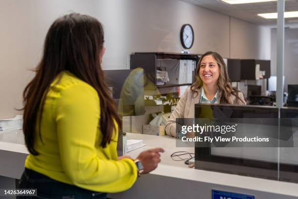 outstanding customer service at a bank - bank office clerks stock pictures, royalty-free photos & images