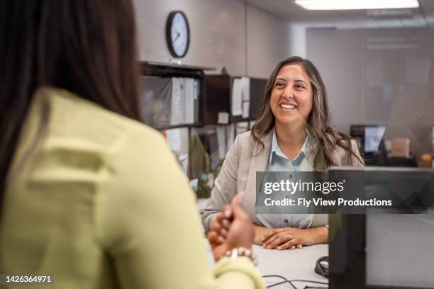 outstanding customer service at a bank - bank teller and customer stock pictures, royalty-free photos & images