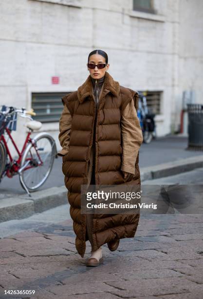 Alexandra Guerain wears brown puffer sleeveless coat, outside Max Mara during the Milan Fashion Week - Womenswear Spring/Summer 2023 on September 22,...