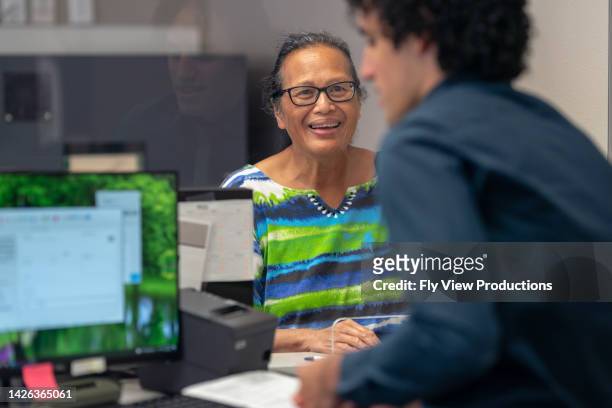 mature adult woman at the bank - bank office clerks stock pictures, royalty-free photos & images
