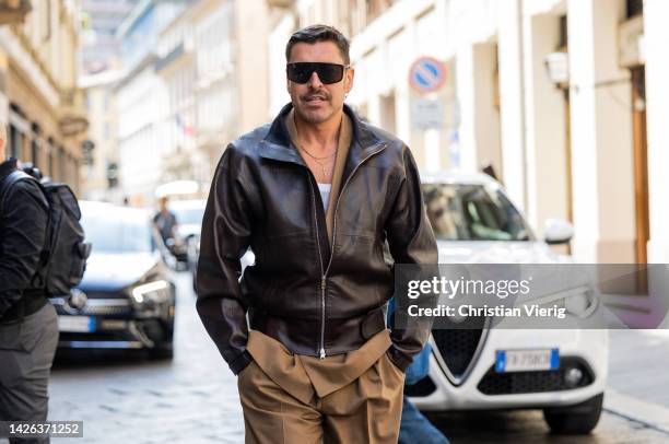 Alex Badia wears leather jacket, brown outside DSquared during the Milan Fashion Week - Womenswear Spring/Summer 2023 on September 22, 2022 in Milan,...