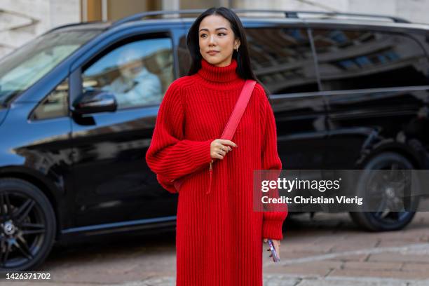 Yoyo Cao wears red knitted dress, belt bag outside Max Mara during the Milan Fashion Week - Womenswear Spring/Summer 2023 on September 22, 2022 in...