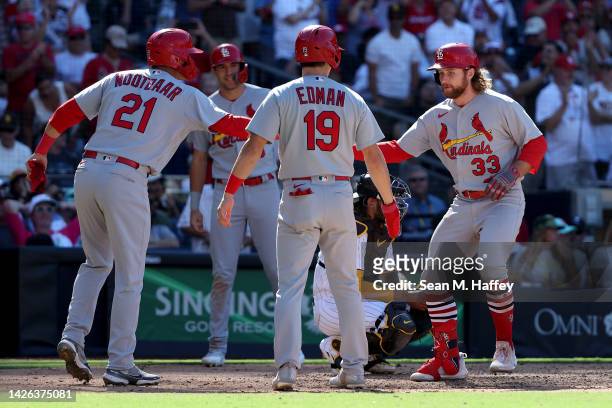 Lars Nootbaar and Tommy Edman congratulate Brendan Donovan of the St. Louis Cardinals after his grand slam during the seventh inning of a game...
