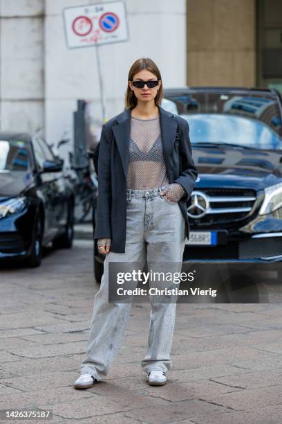 Jacqueline Zelwis wears grey blazer, see trough top, denim jeans in grey outside Max Mara during the Milan Fashion Week - Womenswear Spring/Summer...