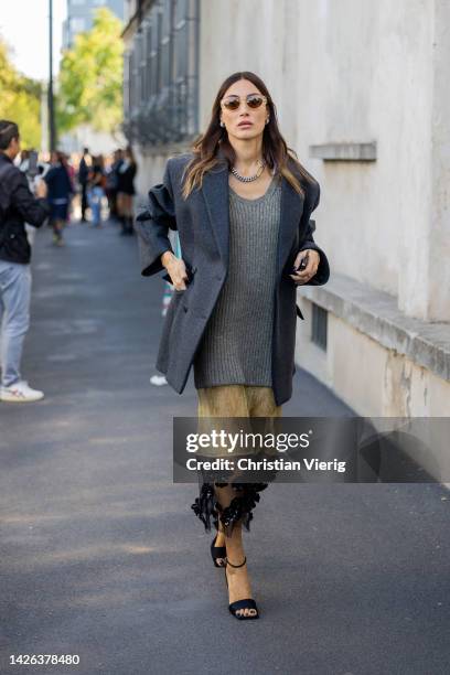 Giorgia Tordini wears grey blazer, knit, two tone beige black see trough skirt, sunglasses, necklace outside Prada during the Milan Fashion Week -...