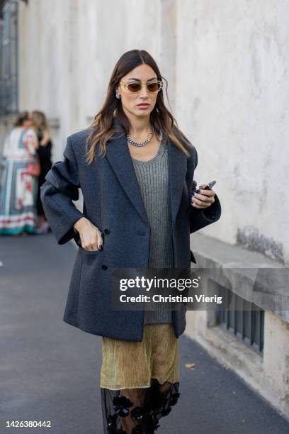 Giorgia Tordini wears grey blazer, knit, two tone beige black see trough skirt, sunglasses, necklace outside Prada during the Milan Fashion Week -...