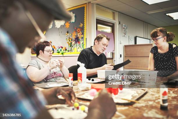 disability health care art workshop, creative paint and down syndrome people doing a project. disabled painter group relax working with craft tools to do a special needs painting with a brush - autistic adult imagens e fotografias de stock