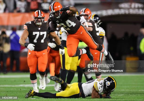 Nick Chubb of the Cleveland Browns rushes over defender Minkah Fitzpatrick of the Pittsburgh Steelers during the first quarter at FirstEnergy Stadium...