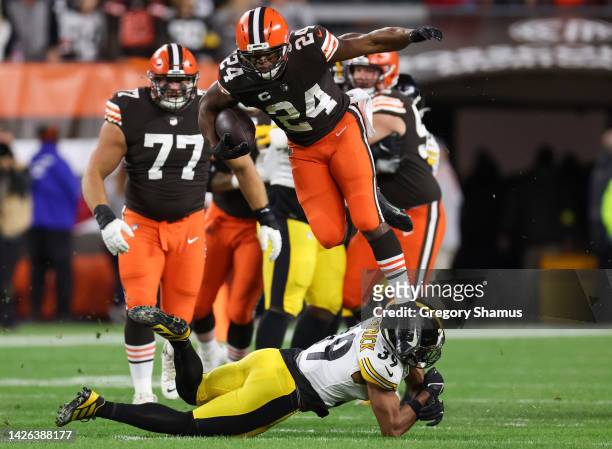 Nick Chubb of the Cleveland Browns rushes over defender Minkah Fitzpatrick of the Pittsburgh Steelers during the first quarter at FirstEnergy Stadium...
