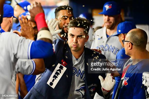 Whit Merrifield of the Toronto Blue Jays celebrates with teammates after hitting a home run in the second inning against the Tampa Bay Rays at...