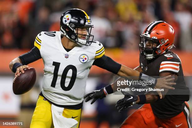 Mitch Trubisky of the Pittsburgh Steelers scrambles from Anthony Walker Jr. #5 of the Cleveland Browns during the first quarter at FirstEnergy...