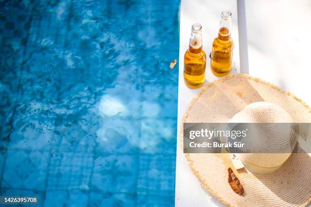 summer and poolside beer party, cold beer - blue hat stock pictures, royalty-free photos & images