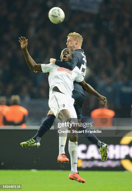 Felix Bastians of Berlin is challenged by Garra Dembele of Freiburg during the Bundesliga match between Hertha BSC Berlin and SC Freiburg at Olympic...