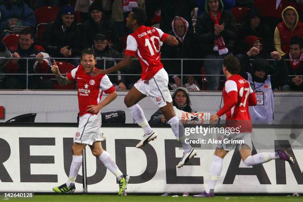 Eugen Polanski celebrates his team's first goal with team mates Eric Maxim Choupo-Moting and Nicolai Mueller during the Bundesliga match between...