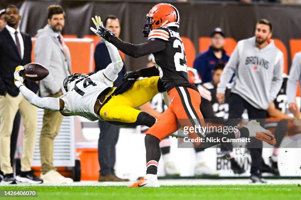 George Pickens of the Pittsburgh Steelers makes a one handed catch ahead of Martin Emerson Jr. #23 of the Cleveland Browns during the second quarter...