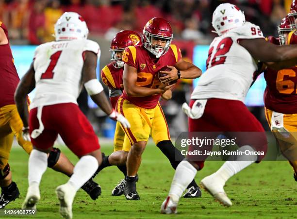 Running back Travis Dye of the USC Trojans carries the ball in the game against the Fresno State Bulldogs at United Airlines Field at the Los Angeles...