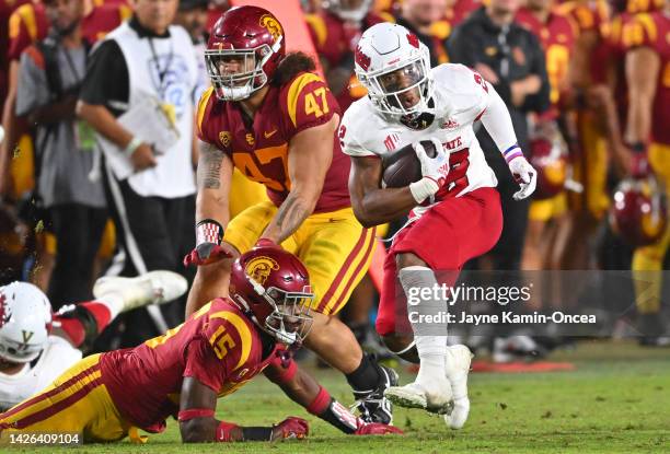 Running back Malik Sherrod of the Fresno State Bulldogs defensive back Anthony Beavers Jr. #15 of the USC Trojans for a first down in the second half...