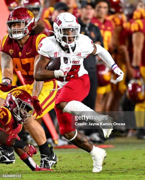 Running back Malik Sherrod of the Fresno State Bulldogs defensive back Anthony Beavers Jr. #15 of the USC Trojans for a first down in the second half...