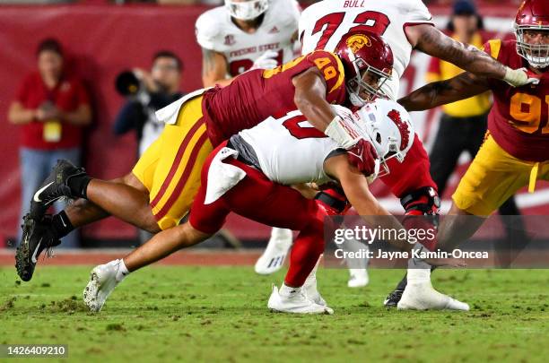 Defensive lineman Tuli Tuipulotu of the USC Trojans sacks quarterback Logan Fife of the Fresno State Bulldogs in the game at United Airlines Field at...